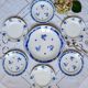 Mismatched old dessert plates accompanied by a dish