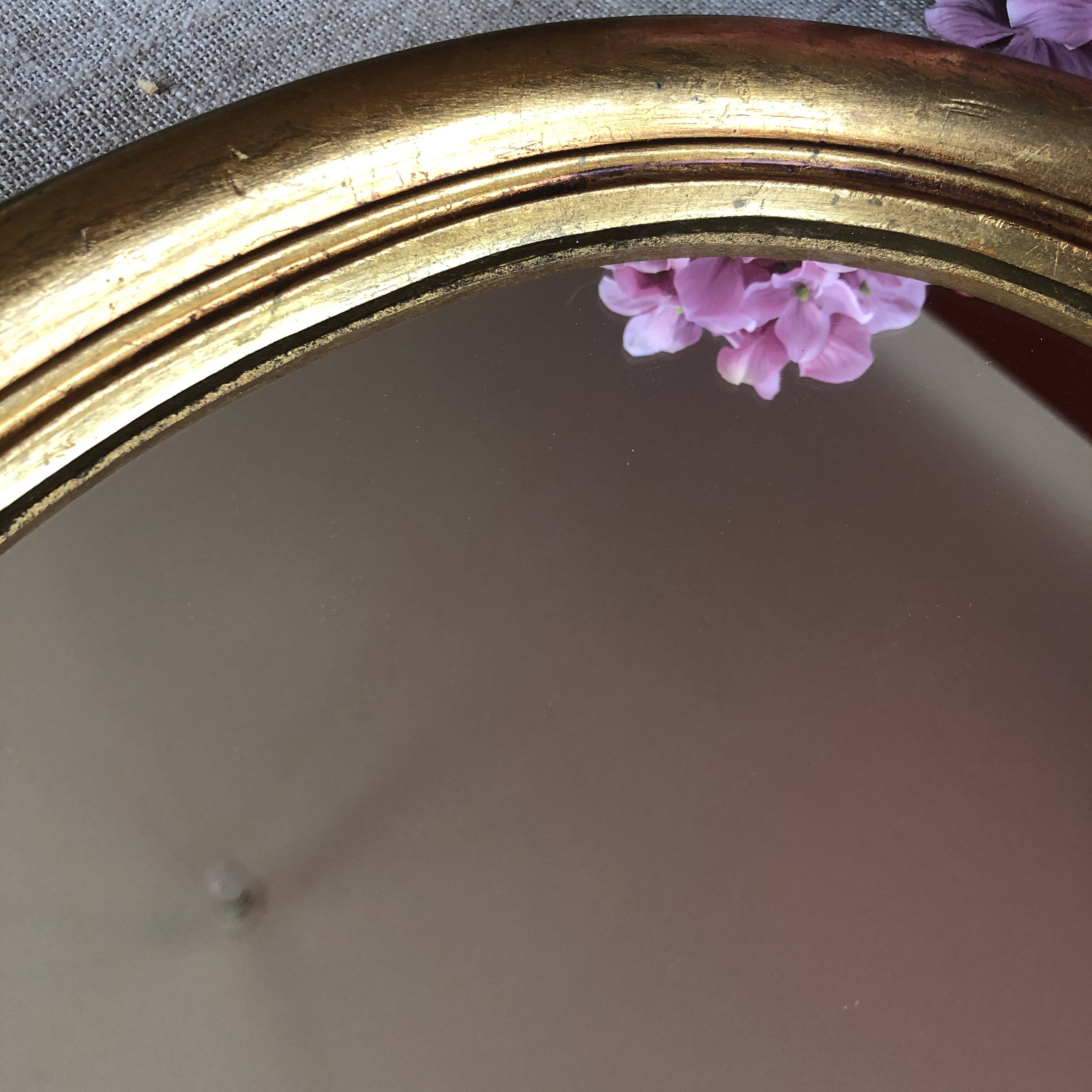 Golden oval mirror