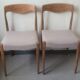 Pair of Scandinavian teak chairs sitting beige gray fabric