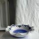 Small hand-painted earthenware salad bowl with garland of blue flowers, mark below