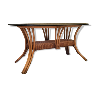 Oval rattan dining table and smoked glass