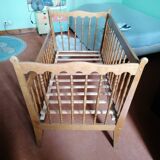 Wooden children's bed with sliding partition.