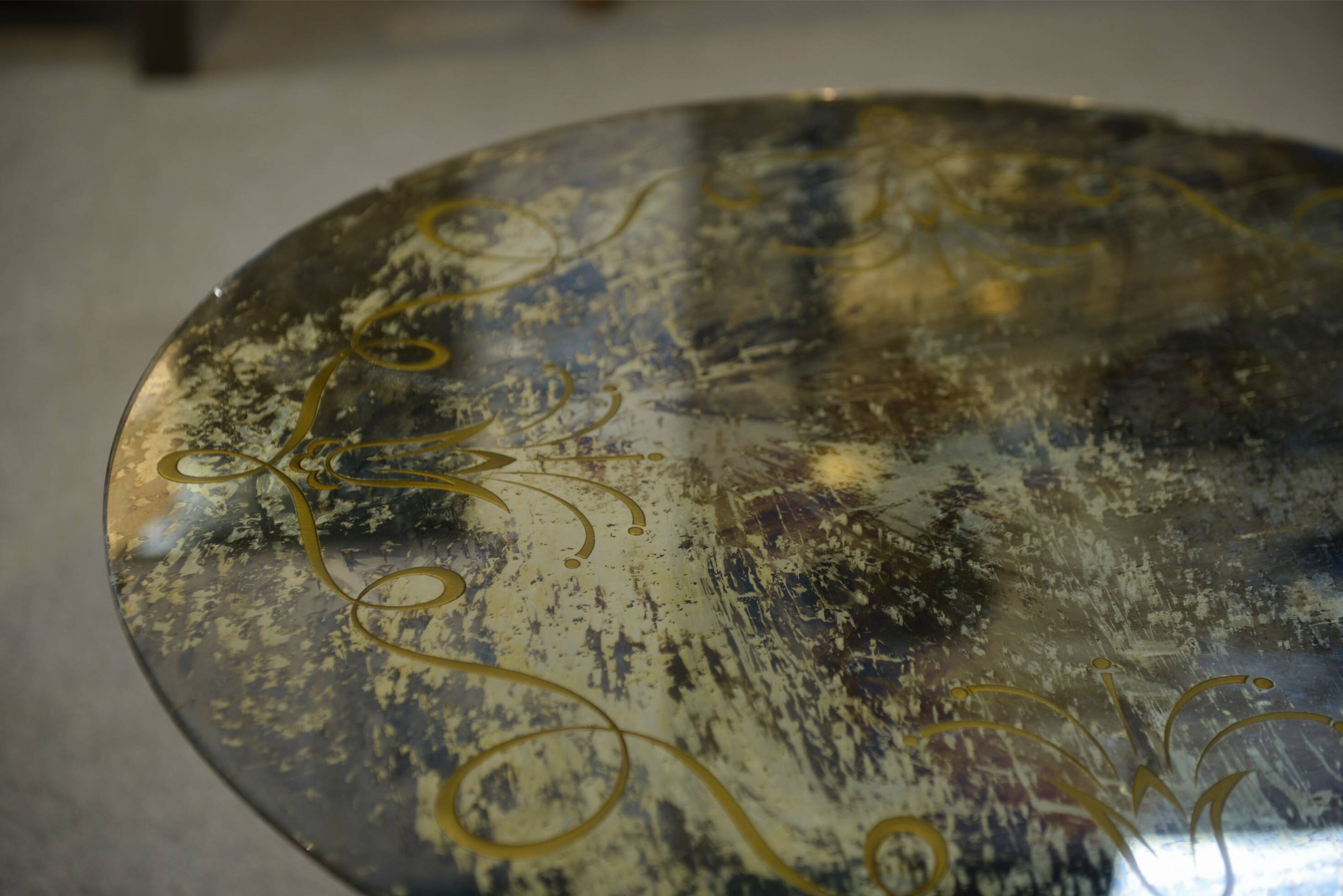 Neo-classical cast iron and glass eglomisé coffee table from the 1940s.