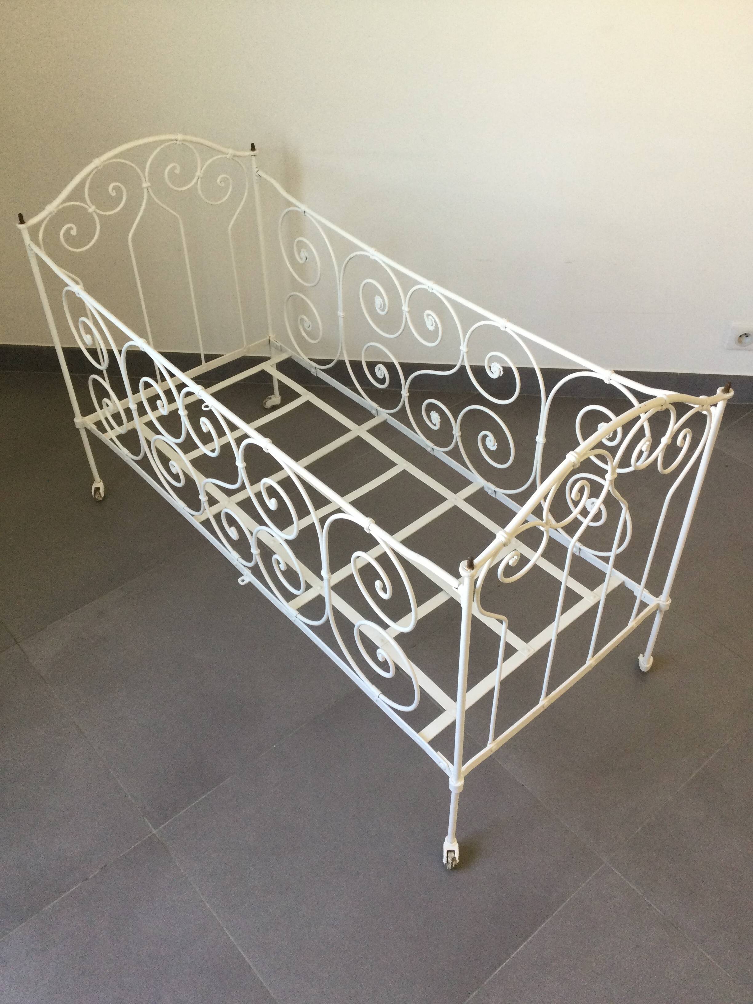 White wrought iron folding bed