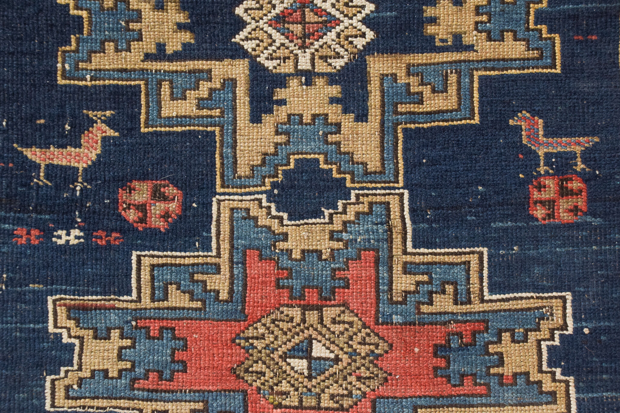 Handwoven blue ground persian rug with bird-like figures