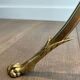 Brass floor lamp with a tripod base and claw feet from Maison Jansen.