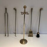 Neoclassical brass fire accessory with duck head decorations.