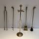 Neoclassical brass fire accessory with duck head decorations.