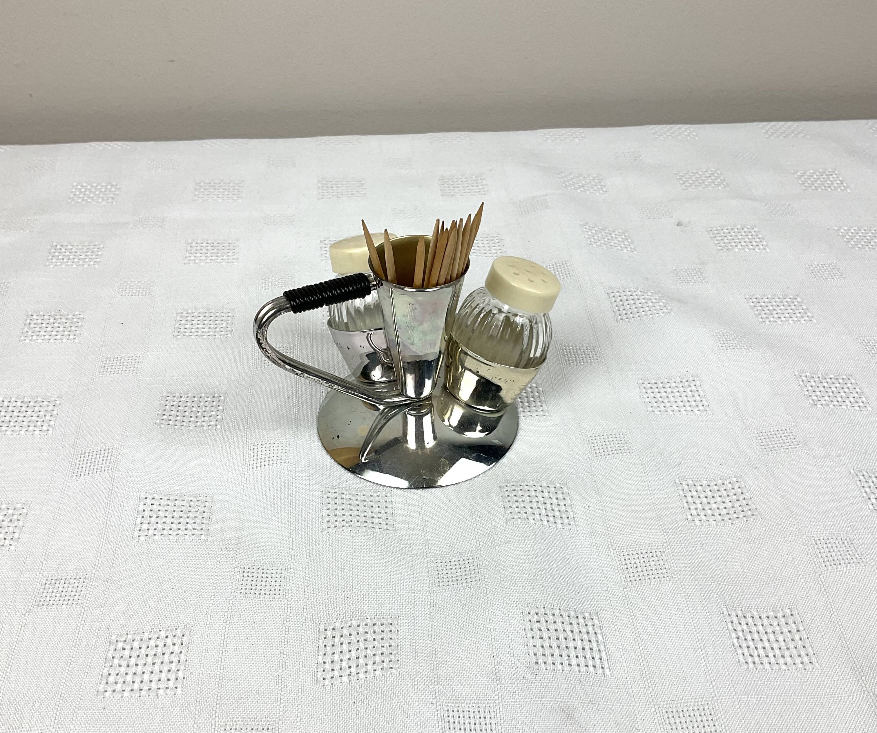 Vintage salt and pepper shakers and their chrome metal support