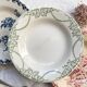 10 mismatched vintage soup plates in blue, green, and red ironstone
