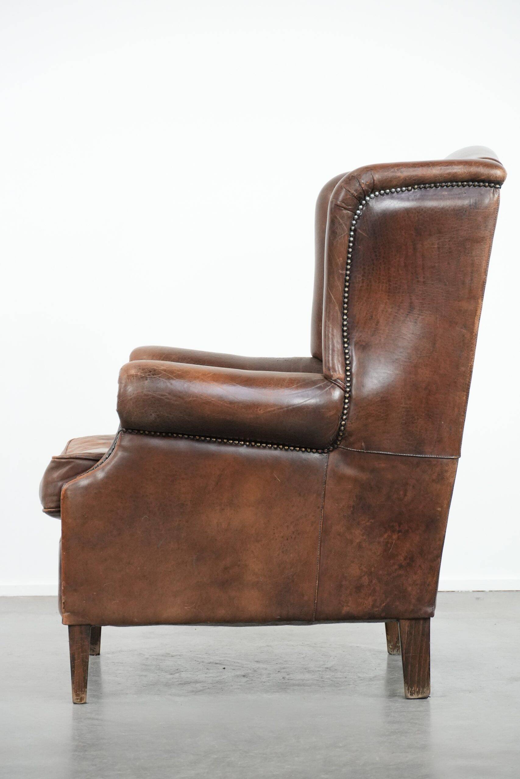 Vintage wingback armchair made of sheepskin leather with beautiful colours