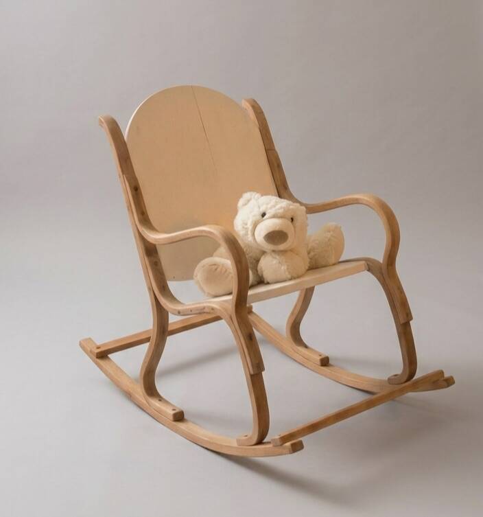 Handcrafted rocking chair in curved wood with a white seat.