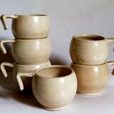 Six vintage potter's ceramic cups with vanilla enamel