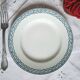Mismatched antique flat plates made of ironstone pottery.