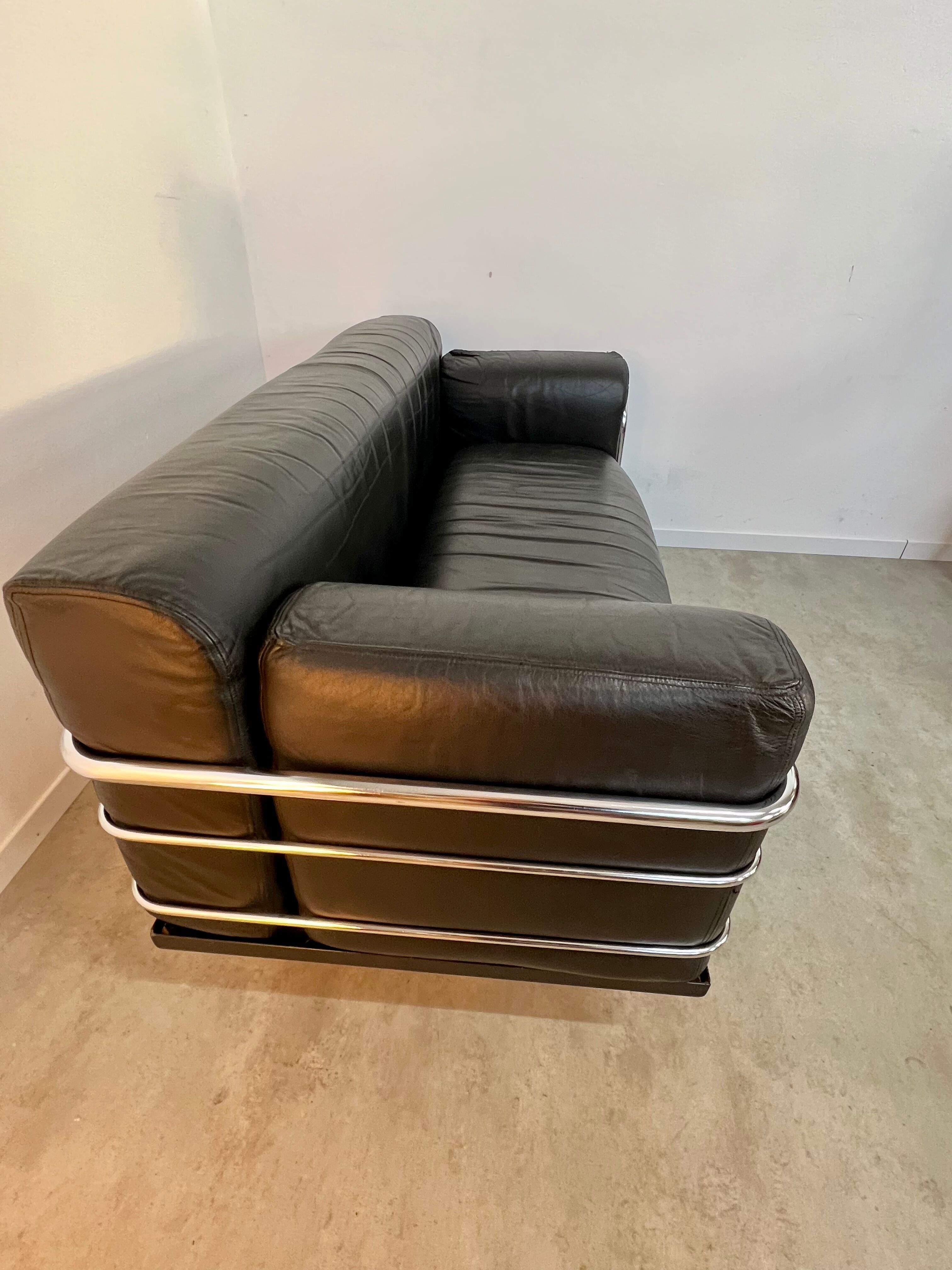 Old vintage leather and tubular metal sofa, design 70s
