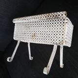 Wrought iron planter hides perforated sheet metal pot