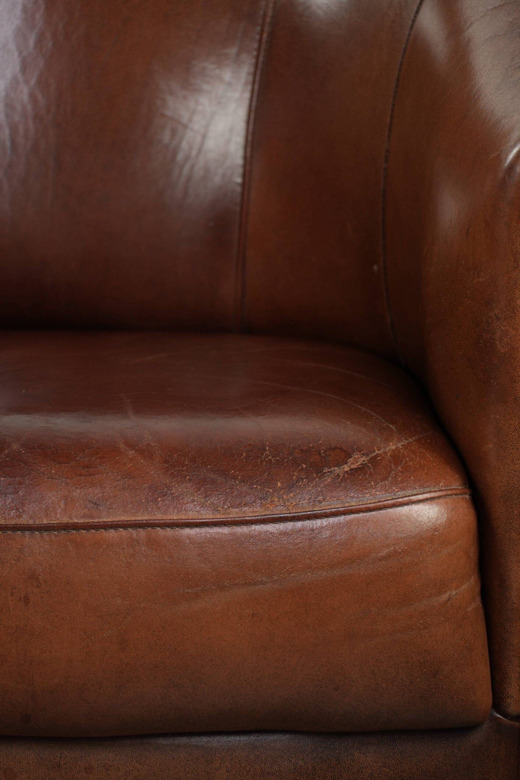 Vintage sheepskin club armchair in English style with deep colours