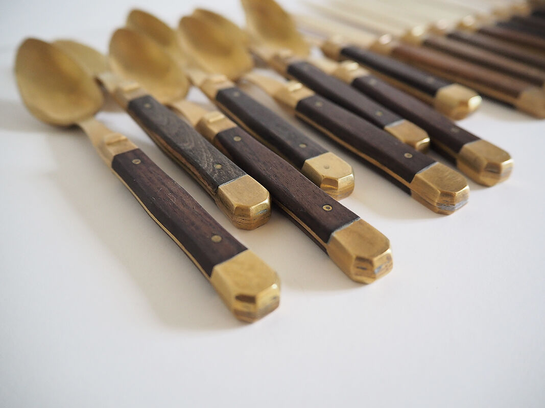 Set of old dessert cutlery in wood and brass