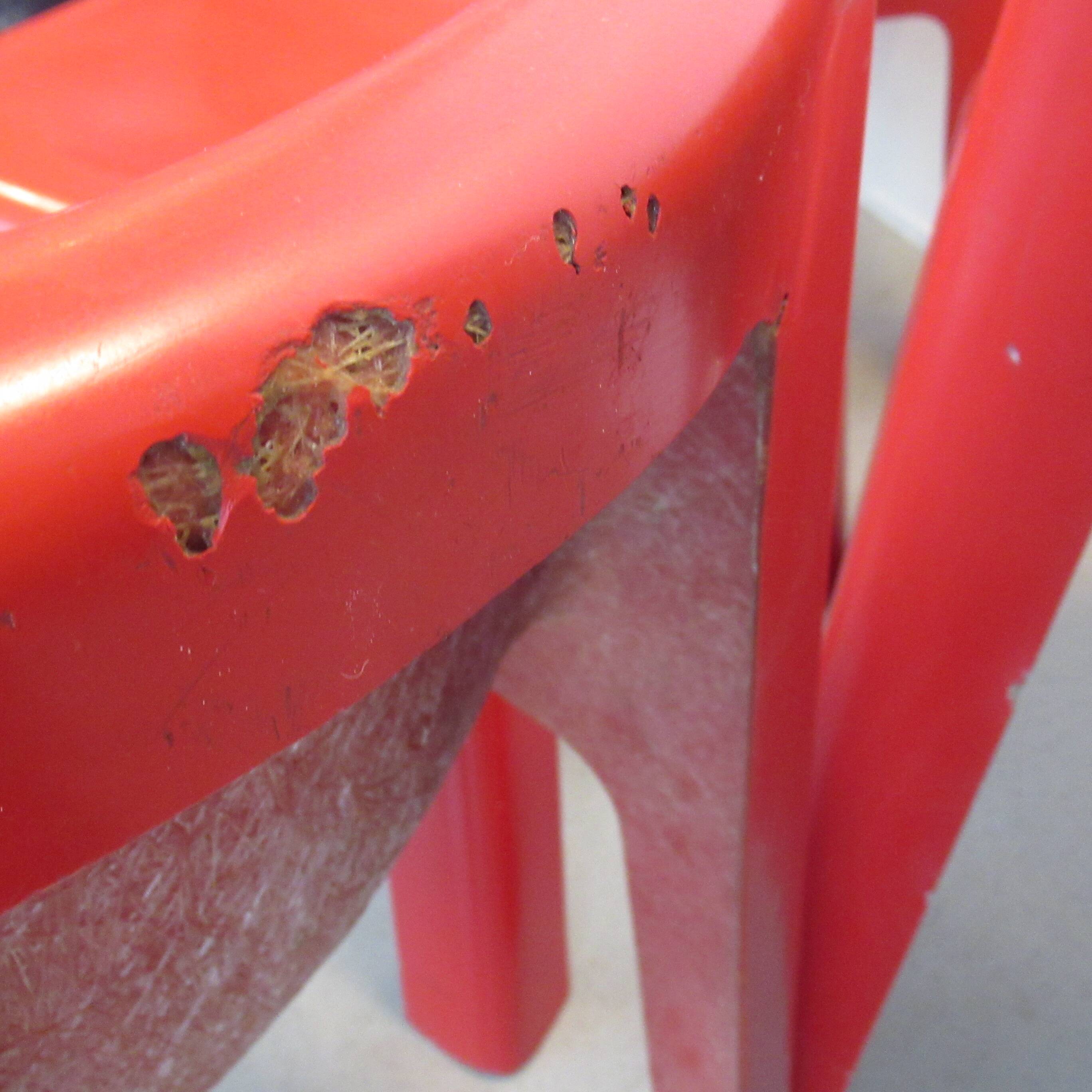 Four red fibreglass chairs from the 1970s.