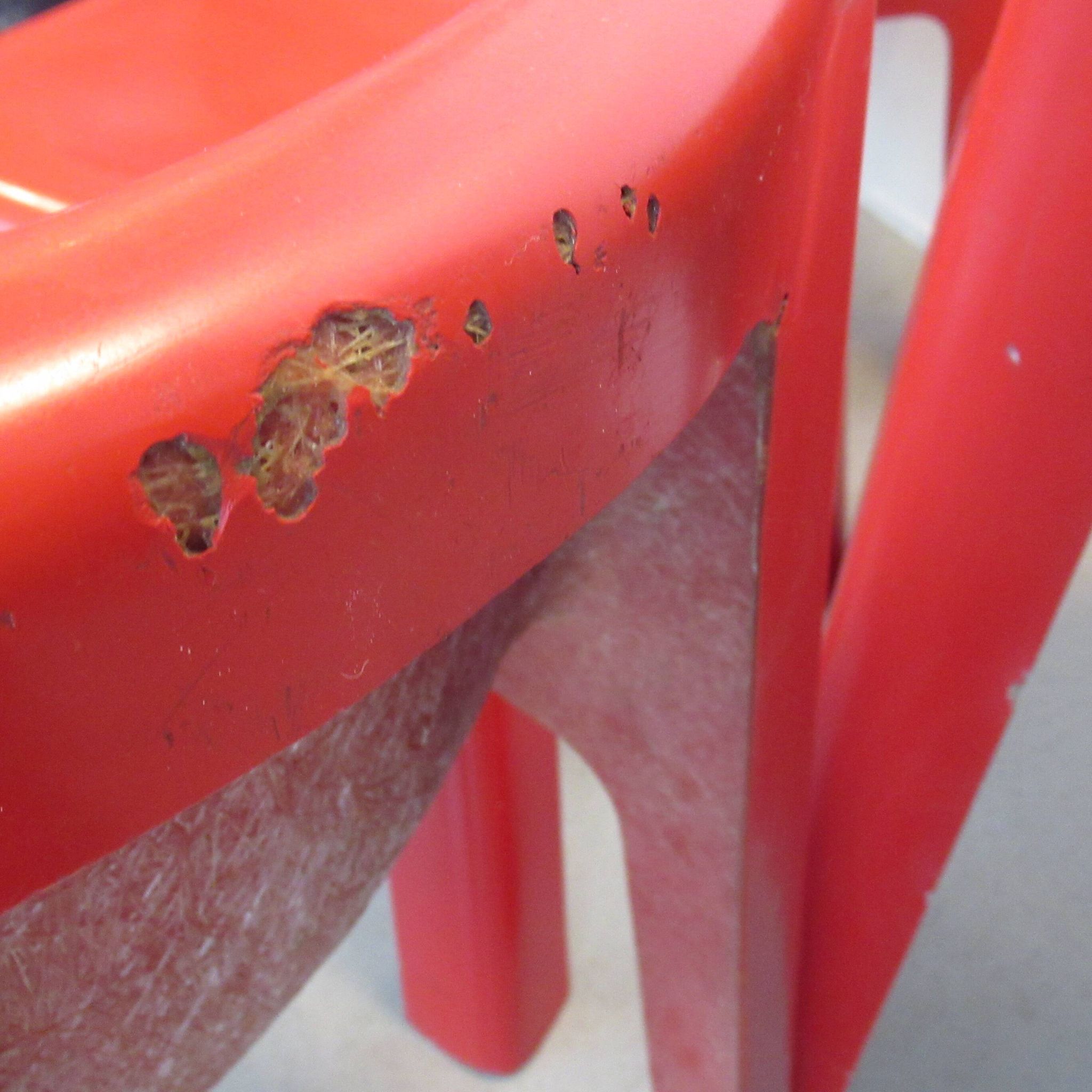 Four red fibreglass chairs from the 1970s.