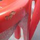 Four red fibreglass chairs from the 1970s.