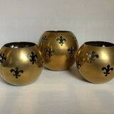 Trio of brass fleur-de-lis candle holders