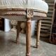 Medallion back chair in moulded wood and beige fabric.