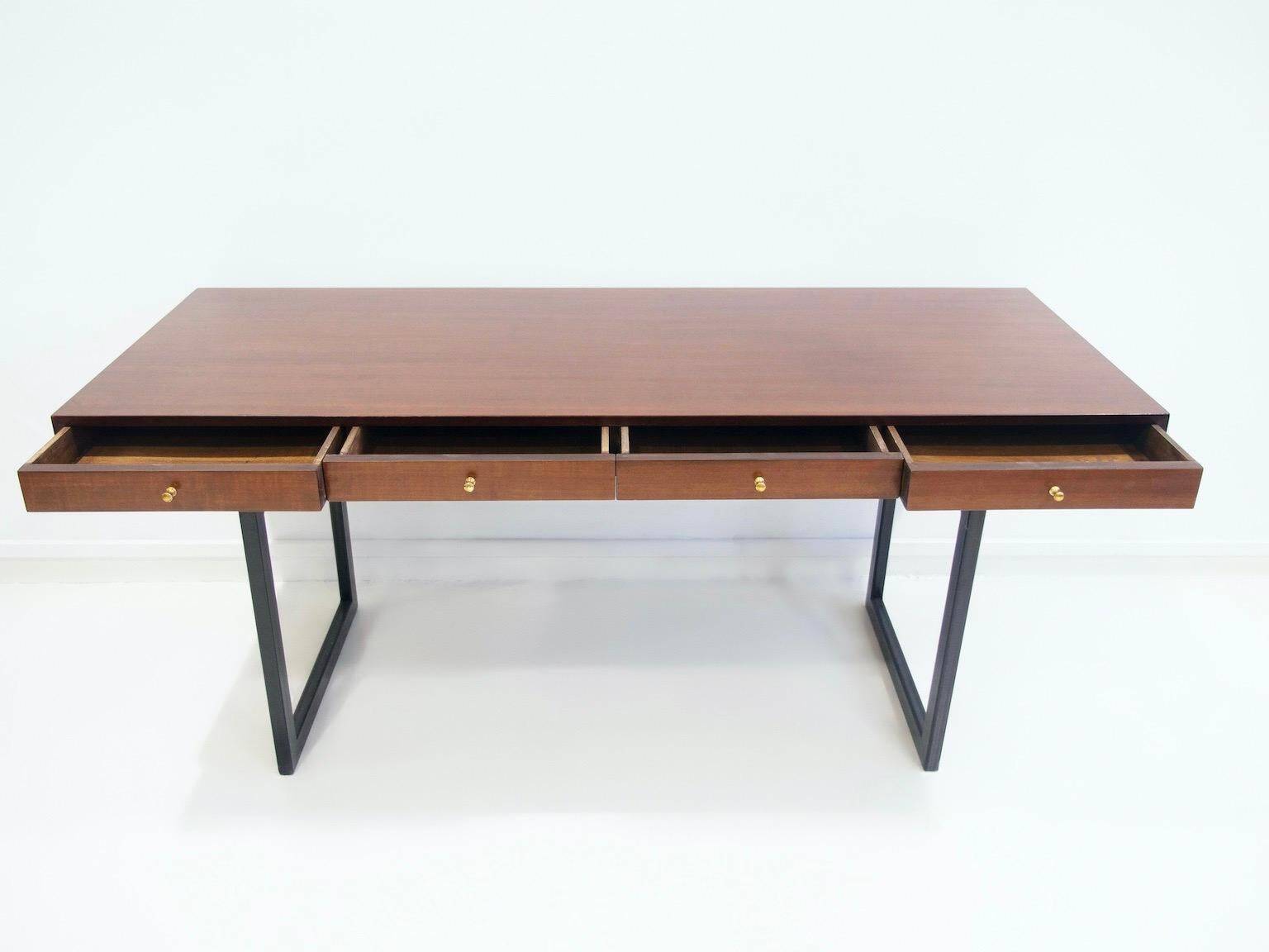 Wooden desk with drawers and black lacquered legs.