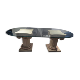 Oval glass table with marble column.