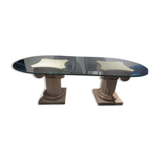 Oval glass table with marble column.