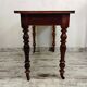 Antique wooden desk with a drawer.