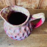Old pitcher in burgundy ceramic