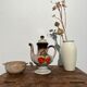 Vintage stoneware teapot with flower and fruit patterns