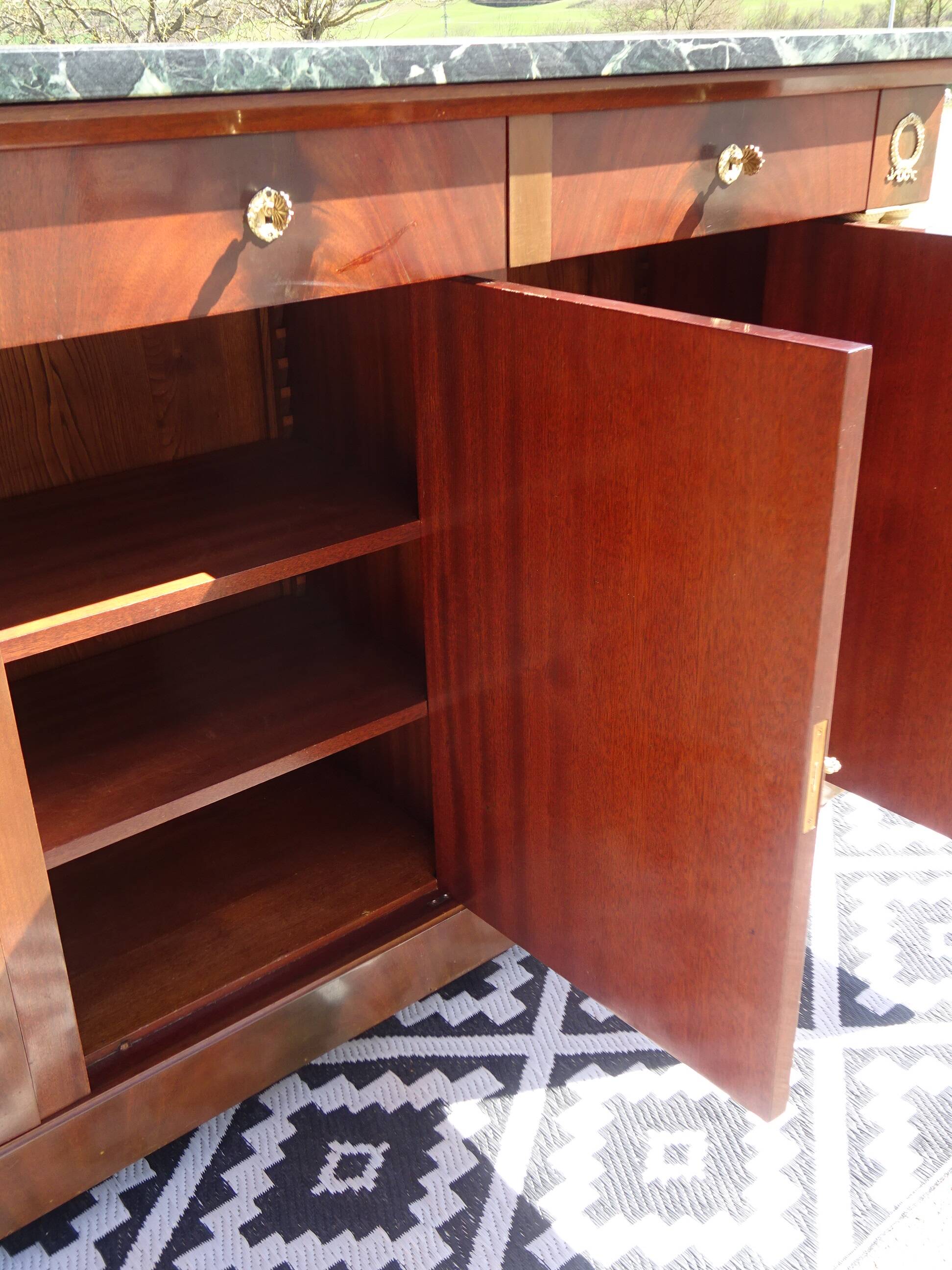 Flamed mahogany enfilade with sea green marble in Empire style.