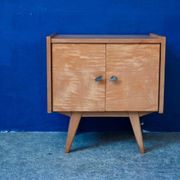 Rockabilly design bedside table with tapered legs.