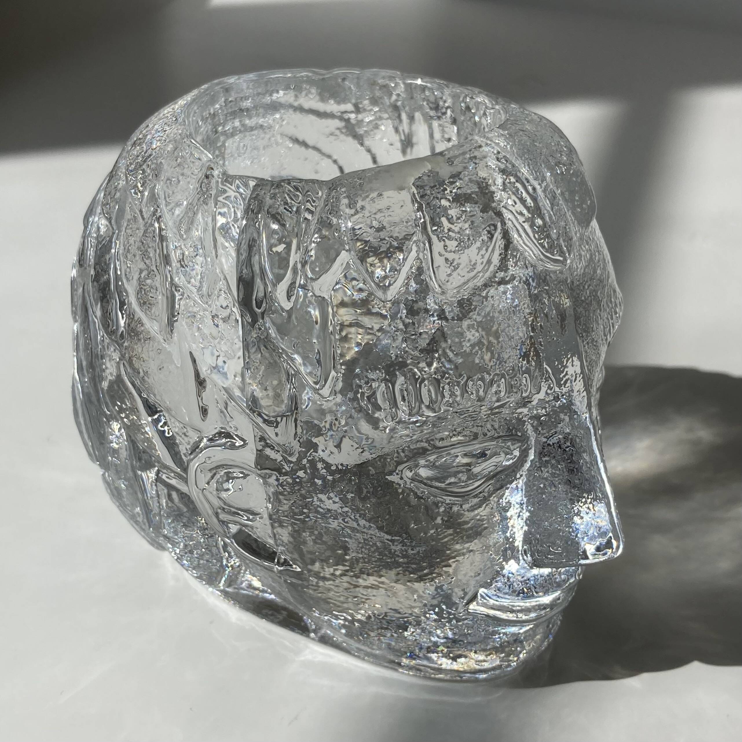 Glass candlestick by Bertil Vallien for Kosta Boda, man's head.