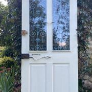 Entrance door in solid oak, cast iron grille, 1930s