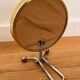 Magnifying brass mirror