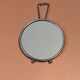 Small round barber-style mirror.