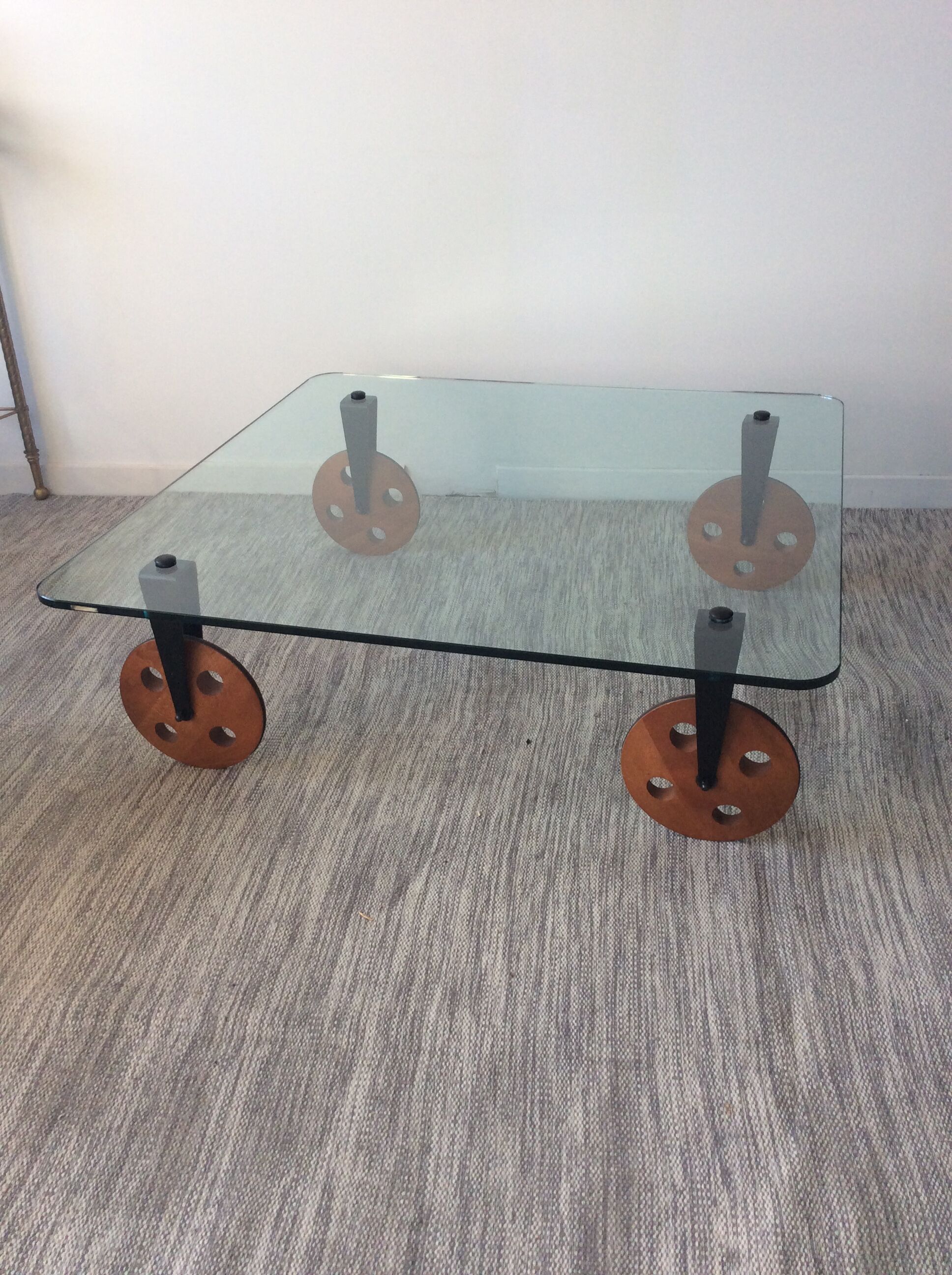 Glass coffee table on teak wheels