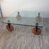 Glass coffee table on teak wheels