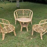 Set of children's rattan garden furniture from the 1950s and 1960s, including chairs, table, and bench.