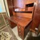 Vintage desk with drawers and a hutch with numerous drawers.