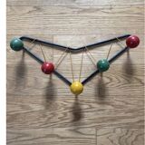 Vintage coat rack in the style of Roger Ferraud.