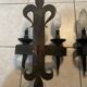 Pair of wrought iron wall lights in fleur-de-lis château style.