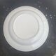 Two earthenware dishes, one hollow and one white cake dish with yellow border