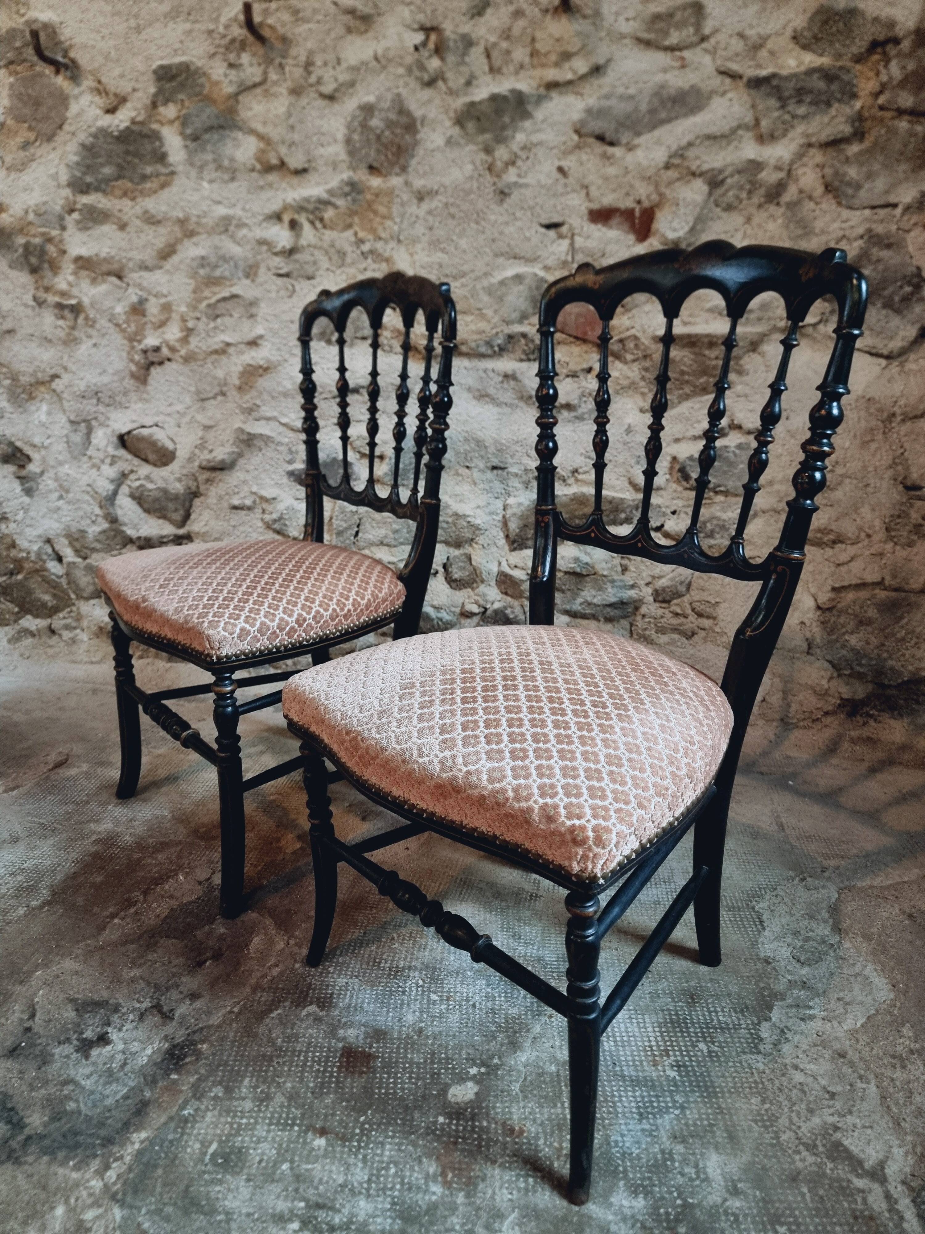 Pair of antique Napoleon III chairs in blackened wood and fabric.