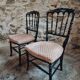 Pair of antique Napoleon III chairs in blackened wood and fabric.