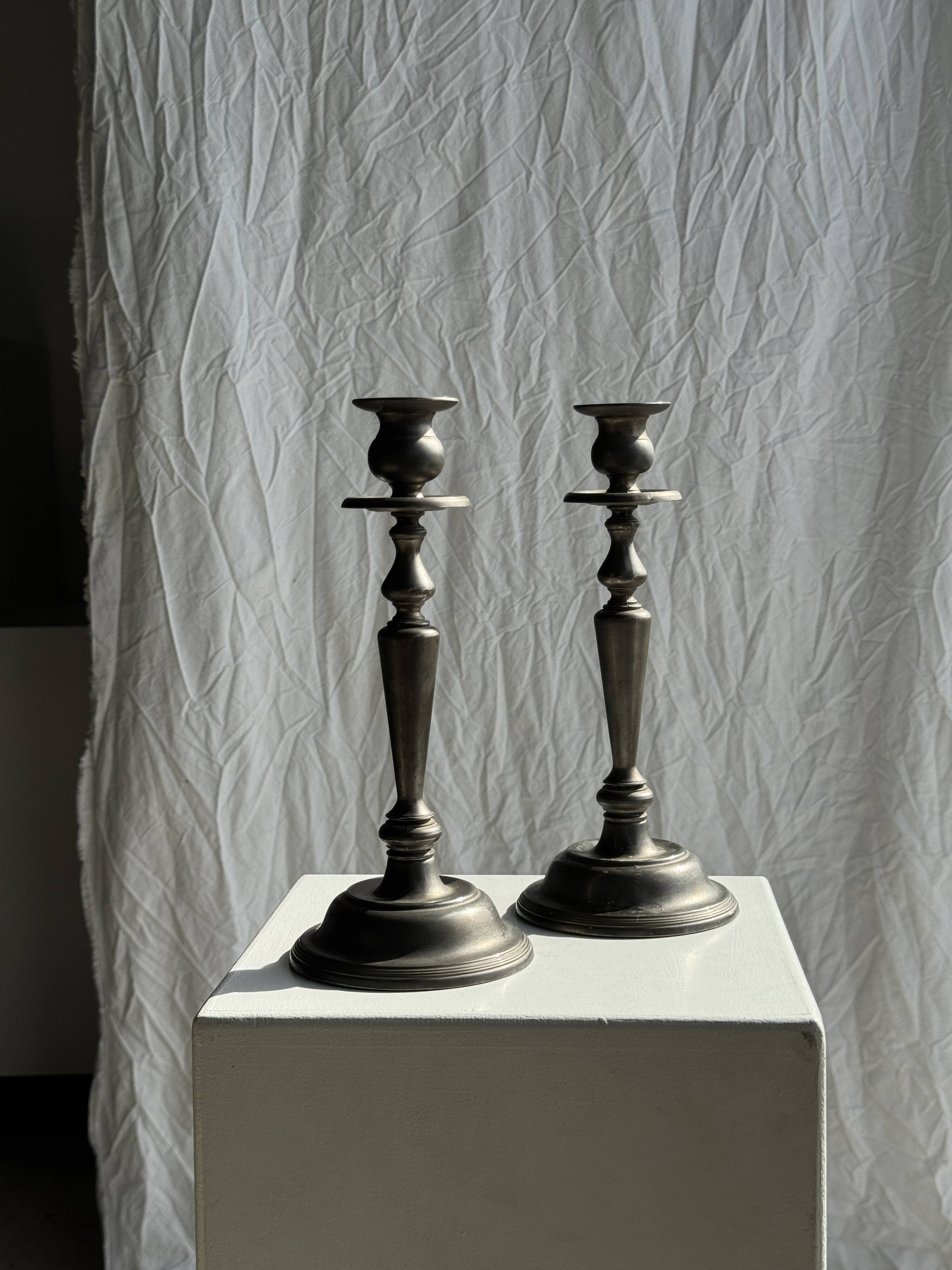 Two large antique silver-plated metal candlesticks, H30