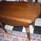 Table ronde a abatants en bois foncé